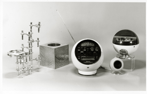 Retro table, waste paper bin and music players (b/w photo)