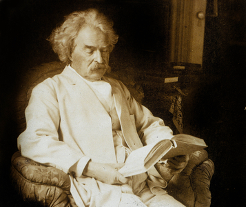 Mark Twain (Samuel Langhorne Clemens 1835-1910) American writer, here reading, c; 1910