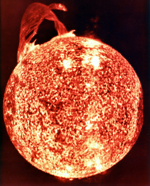 One of the most spectacular solar flares (upper left) ever recorded spanning more than 588,000 km across the solar surface. NASA photograph.