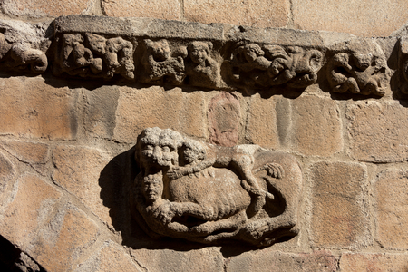 Cathedral. Exterior. West façade. Detail. The frieze. Sculpture of a lion, a nude man. Romanesque. 12th century.