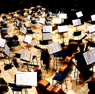 Stage set up for orchestra with music stands and open score sheets, Paris, 2002.