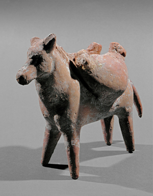 A horse carrying 2 sacks from which two lamb heads protrude …