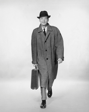 Studio portrait of businessman carrying briefcase