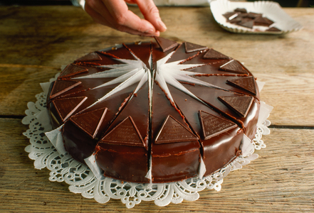 Delicious-looking, large version of Demel's "Sacher Torte" rests on paper lace on a..., 1984 (photo)