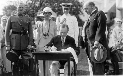 John Calvin Coolidge (1872-1933) 30th President of the USA 1923-1929 (Republican), signing Veterans' Bill and other bills on the White House Lawn, 1924. General of the Armies John Joseph Pershing (1860-1948) looks on. America 