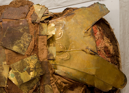 After removing some of the gold sheets, a  golden mask with a monkey image is revealed.