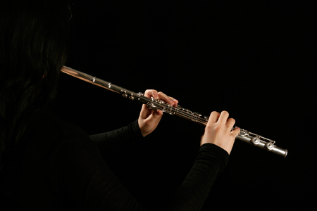 Young woman playing the flute