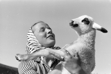 A young woman holding a spotted goat kid, St Märgen in the Southern Black Forest, Germany 1930s (b/w photo)