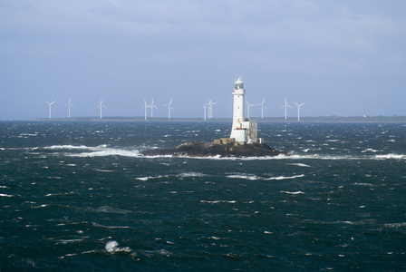 Lighthouse on Tuskar Rock in Irish Sea and Carnsore Point windfarm, near Rosslare, Wexford, Republic of Ireland (photo)
