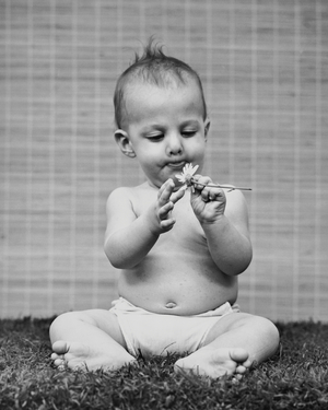 Baby holding a flower