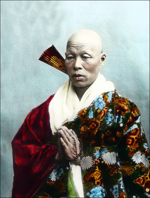 Japan: Buddhist monk in elaborate robes with fan and prayer beads, c.1900