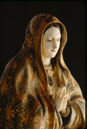 Gold leaf embellishes a wooden mantle framing Our Lady of Guadalupe., 1990 (photo)