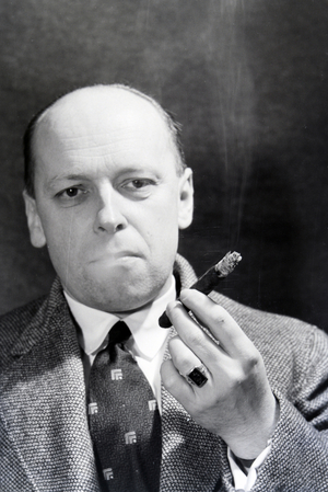 A man smoking a cigar for an advertising campaign, Germany 1930s (b/w photo)