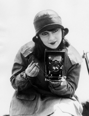 Woman with camera (b/w photo)