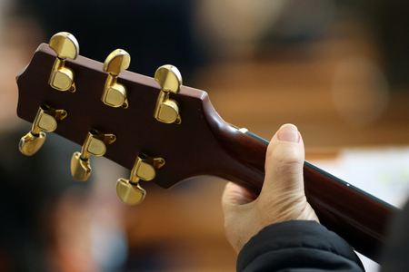 Catholic mass. Guitar player. Close-up on hand.  Saint Francois de Sales church.  Annecy. France.