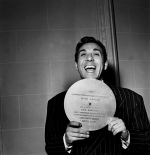 Singer Luis Mariano Receiving Symbolic Record For The Millionth Release of his Song "Maria Luisa" December 28, 1953 (b/w photo)