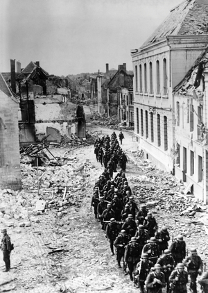 German infantry marching through a French town, 1940 (b/w photo)