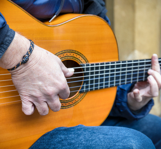 Close up of man playing guitar, 2019 (photo)