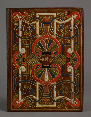 'The interlacing design used on this sixteenth-century French brown calf binding has been economically applied using a single large decorative block.
The sacred monogram (IHS) has been gold-tooled on the upper cover and the initials MA for Maria on the lower, both appropriate for a devotional work. The initials FB may represent the owner's name. (See 'Beautiful bookbindings' by PJM Marks.)