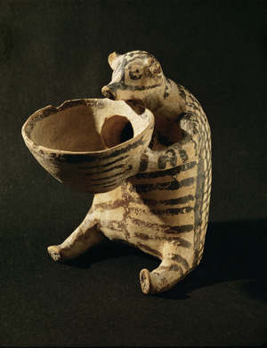 Hedgehog-shaped pink micaceous clay vase with partly effaced black-brown and dull red paint on white veneer (clay)