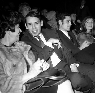 Jacques Brel and Emmanuelle Riva at the premiere of the film Les Risques du Métier at the Paris Coliseum, France, December 21, 1967 (b/w photo)