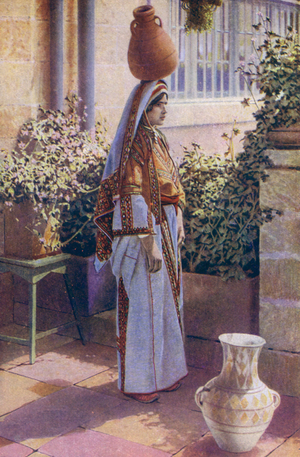 Young woman carrying water on her head, in Bethlehem, Palestine (photo)