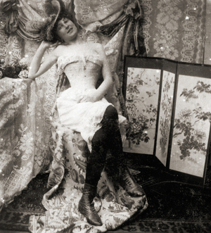 Stereoscopic card depicting a young woman in corset and undergarments, c.1900 (sepia photo) (see also 473239)