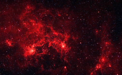 The nebula nicknamed "the Dragonfish." This turbulent region, jam-packed with stars, is home to some of the most luminous massive stars in our Milky Way galaxy. It is located approximately 30,000 light-years away in the Crux constellation. Spitzer.
