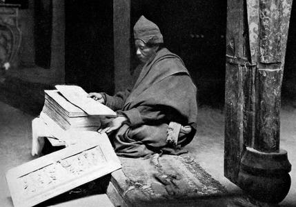 Tibetan monk reading the Kangyur