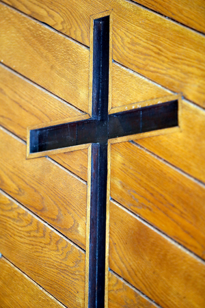 Santa Maria Assunta church. Christian cross on a door. Muggia. Italy.