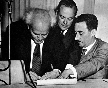 David Ben-Gurion signing the "Proclamation" (b/w photo)