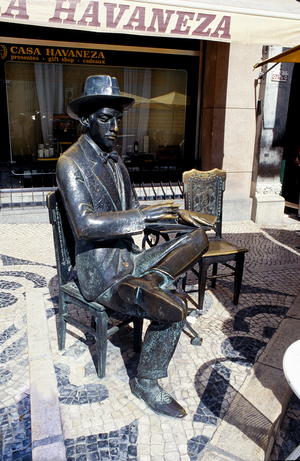 Statue of  Fernando Pessoa  sits outside the cafe Brasiliera in Chiado Lisbon Portugal (photo)