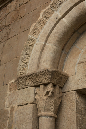 Parish church (Església de Torredenegó). Exterior. Entrance portal. Detail. A Capital. Romanesque.