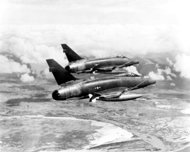 Vietnam: Two USAF F-100D Super Sabre aircraft streaking over South Vietnam on their way to an assigned target (1967). The aircraft provided much of the tactical air support to Allied ground forces fighting in Vietnam.