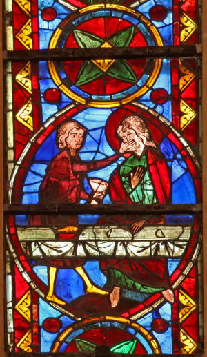Window w213 depicting a scene from the life of St Thomas: the saint at a marriage banquet for the daughter of the king of India has his face slapped by a cupbearer (stained glass)