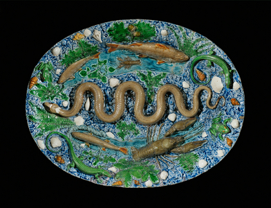 Oval dish decorated with rustic figulines, a serpent ...