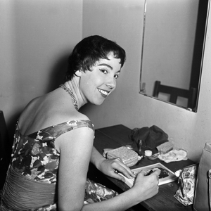 Singer signing autograph cards at her wardrobe in Hamburg, Germany 1950s