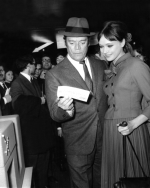 Eddie Constantine and Anna Karina at Premiere of Film Alphaville, A Strange Adventure of Lemmy Caution on May 6, 1965 (b/w photo)