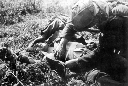 Medic helps a wounded man (b/w photo)