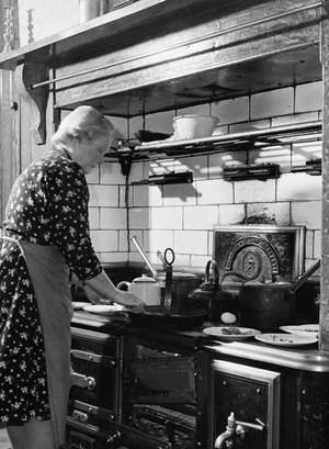 Side profile of a mature woman cooking food in the kitchen