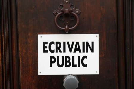 Public letter writer sign on a door. Cannes. France., 2021 (photo)
