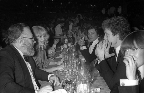 Italian film director Sergio Leone and French actress Mireille Darc at a dinner in Casino Ruhl Nice, on January 14, 1977 (b/w photo)