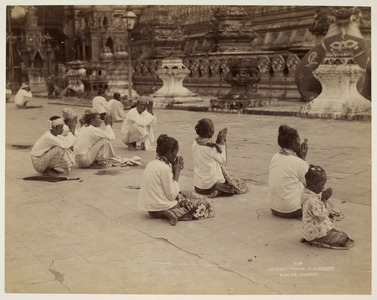 Morning prayer, S.D. [Shwe Dagon] Pagoda [Rangoon]. Group of men and women at prayer on the platform of the Shwe Dagon Pagoda.