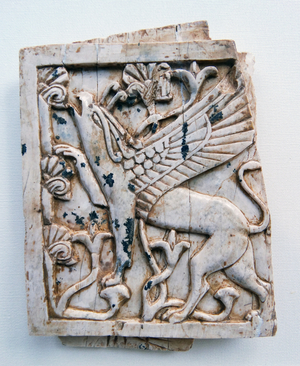 Ivory depicting a griffin eating leaves from a tree