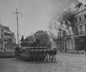 A British tank with a mine clearing machine on the front with british soldiers operating it, 1942 (b/w photo)