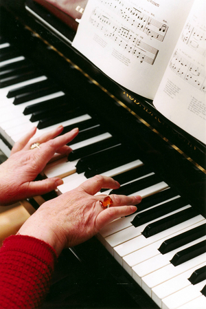 Old people home resident playing music, 1996 (photo)