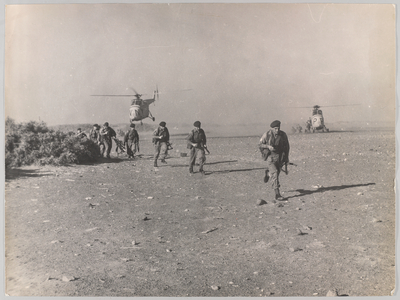 Troops disembark from helicopters, 1964 (b/w photo)