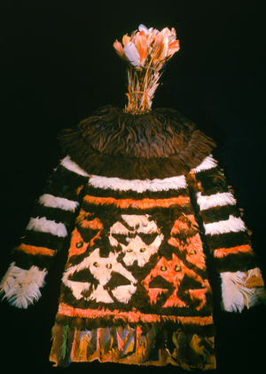 An elaborate headdress with imported bird feathers and fish designs with a foot-tall crown, two earflaps, and a long panel that draped down the back of the wearer, who would have been a person of high rank.