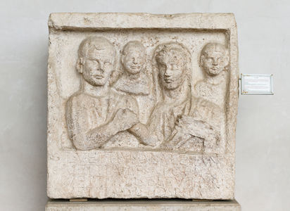 Funerary relief made by Vettia Hospita for her husband Lucius Vettius Alexander and her daughter Vettia Polla, depicting Vettius and his wife in the act of the dextrarum iunctio with two smaller busts behind, Augustian age, travertine marble, National Roman Museum at the Baths of Diocletian, Rome, Italy