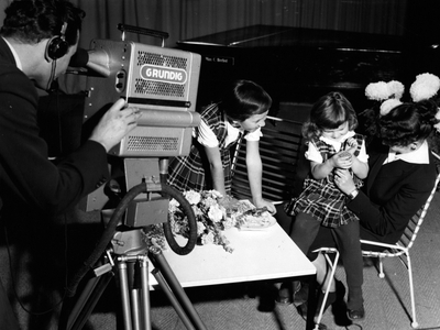 Oct. 23, 1953 - This little birthday girl was one of many to take a turn in front of the camera at a television exhibition at Hamburg's exhibition park, Planten un Blomen.